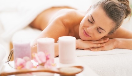 Closeup on spa therapy ingredients and relaxed young woman in ba